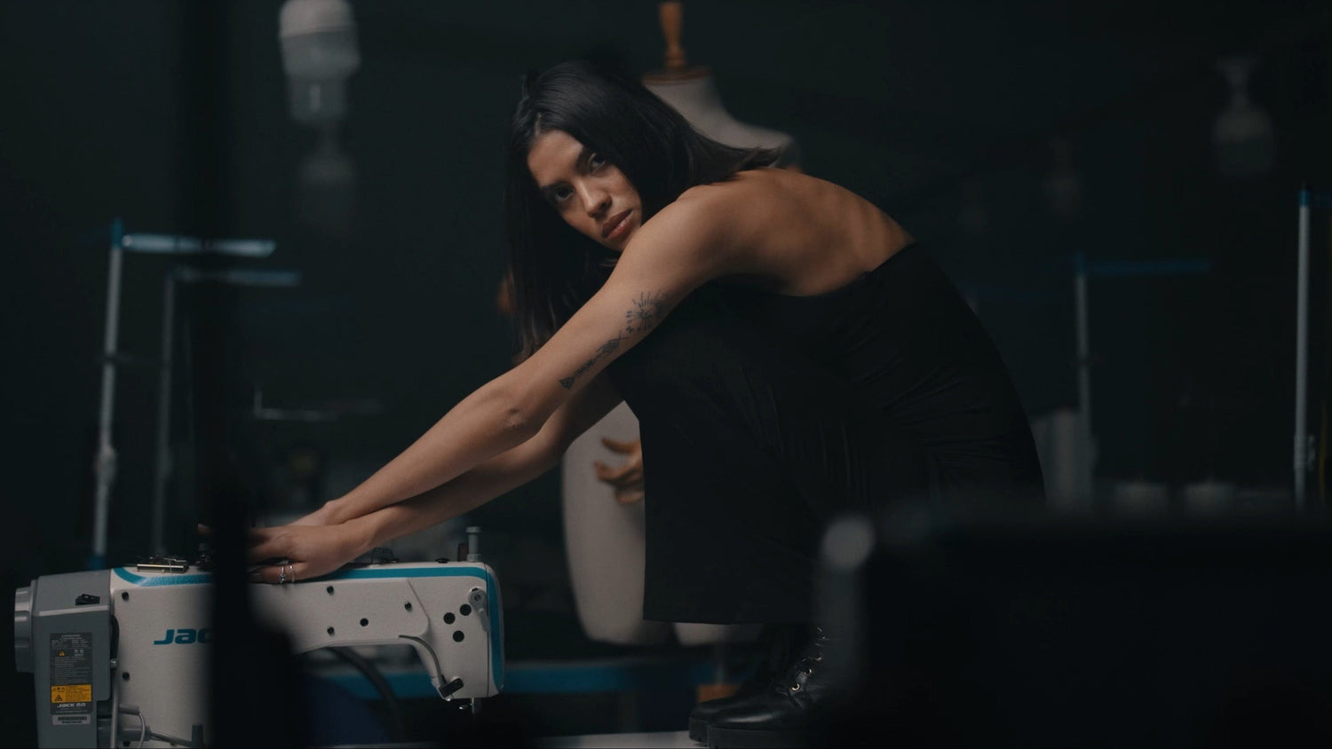 Person working on a machine in a dark setting